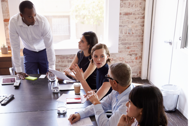 Business people in a conference room discussing the Revenue Ecosystem