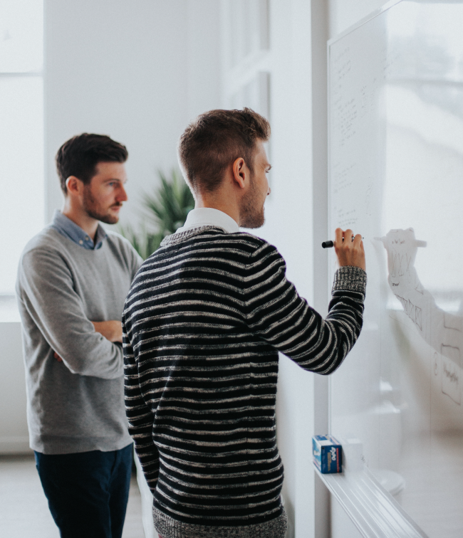 Two colleagues working through the six steps of the Revenue Ecosystem®