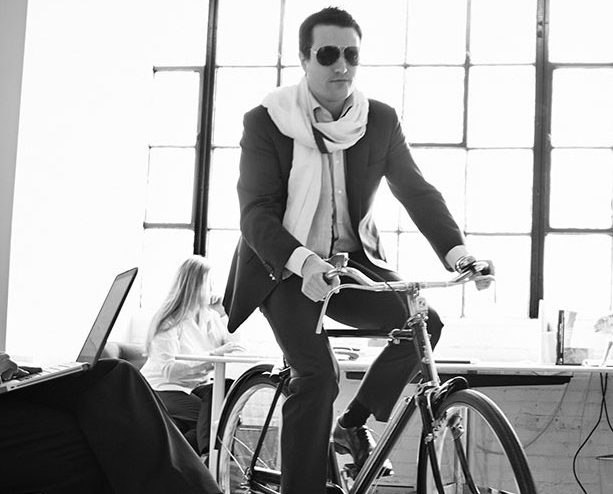 DemandLab CFO riding a bike inside office