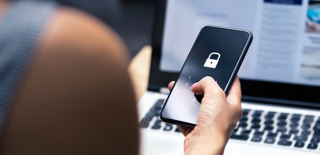 Person holding cellphone with lock screen to represent privacy