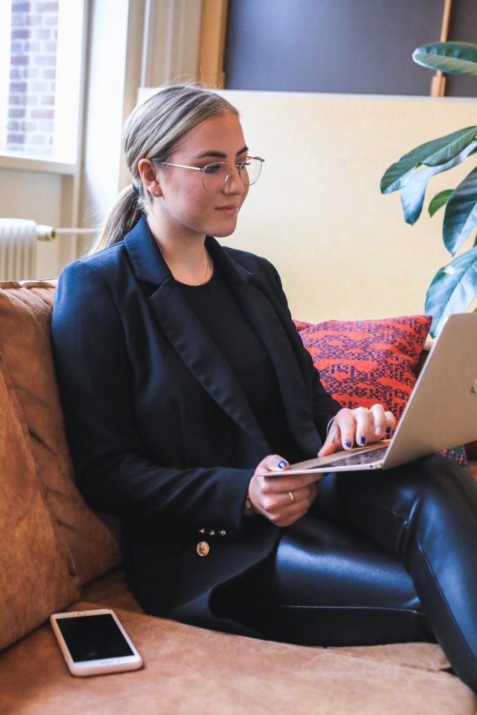 Prospective female employee viewing DemandLab's career benefits on laptop